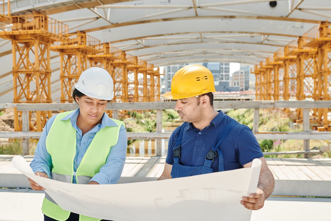 Site crew reviewing building plans together