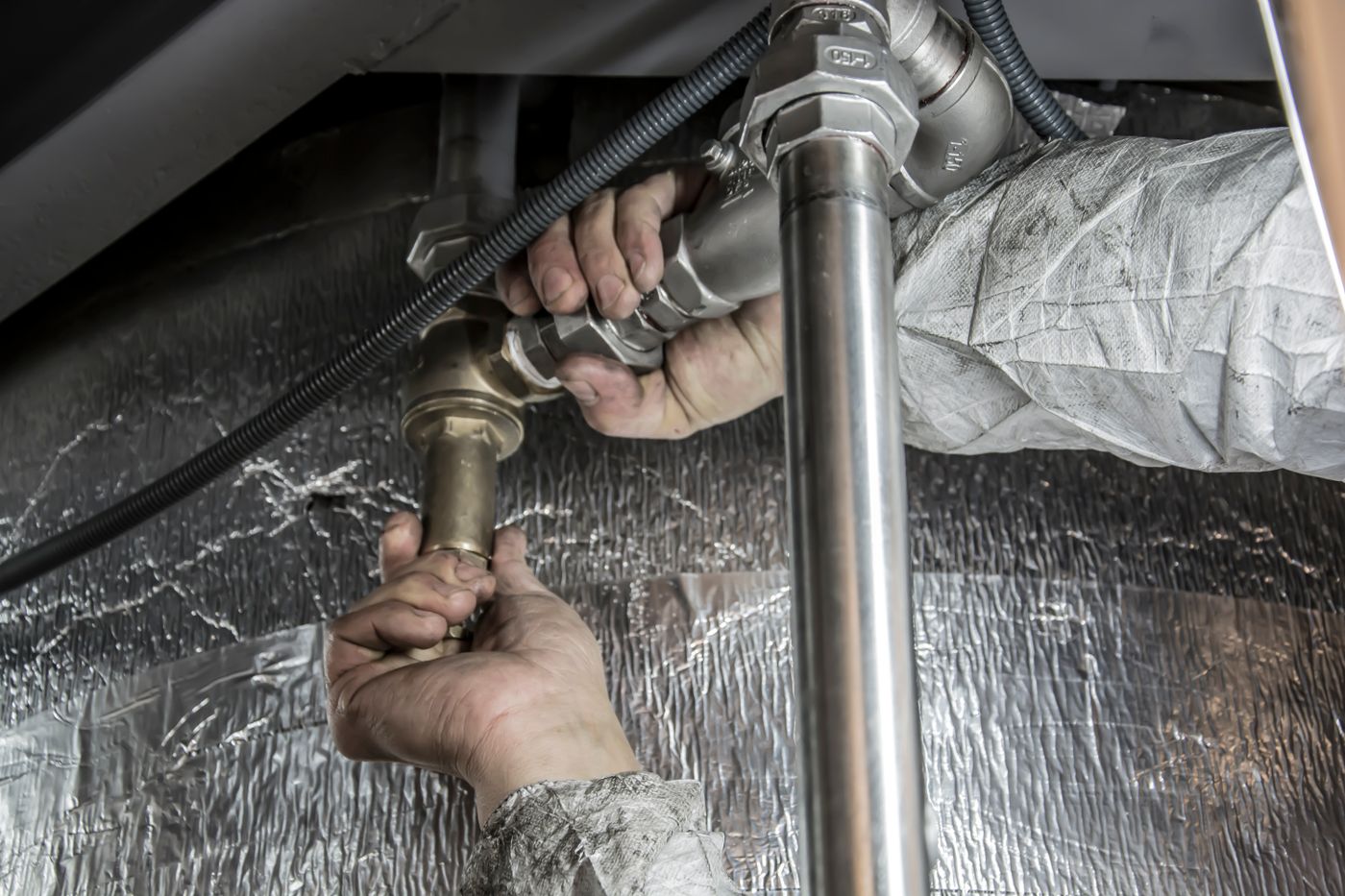 Plumber fitting brass and steel pipe connections by hand